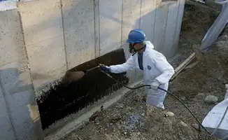 Professional waterproofing the exterior walls of the basement in Los Angeles, CA