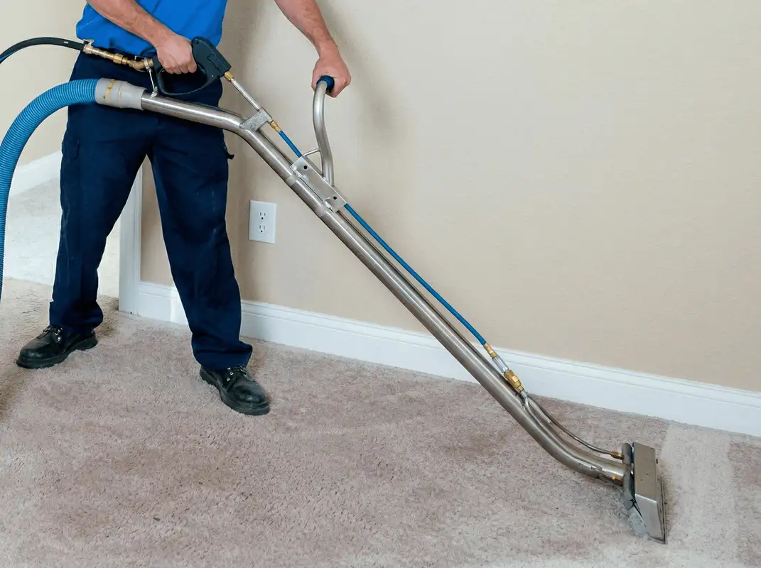Professional operating a liquid removal machine on a carpeted floor in Los Angeles, CA